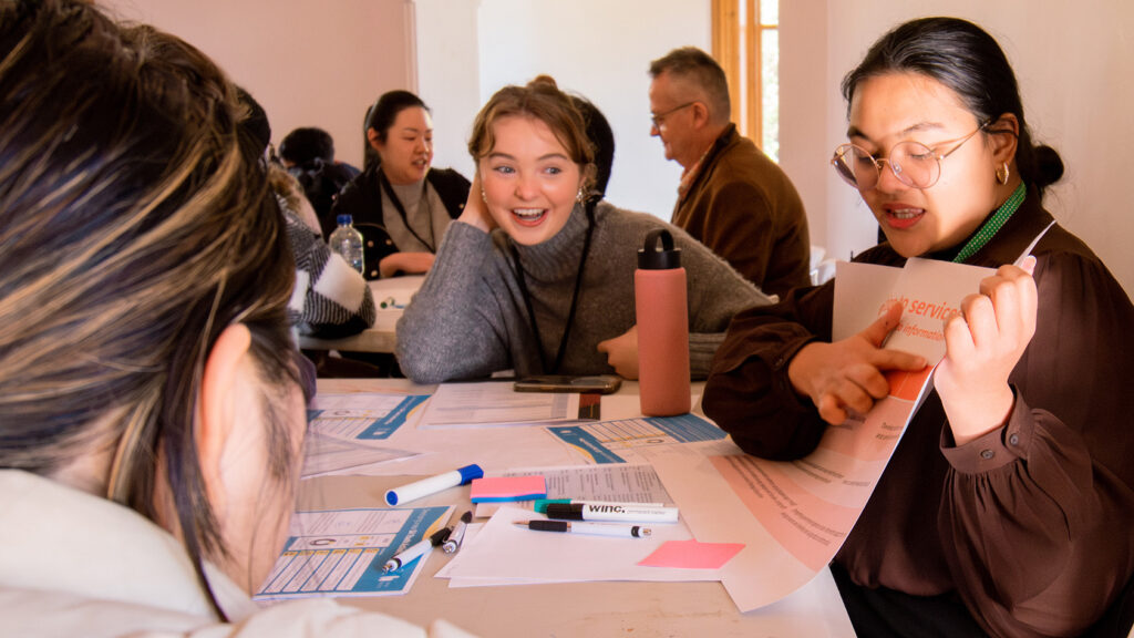 A group of young people enjoying collaborating in a workshop setting 